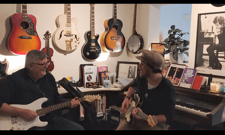 Harry teaching guitar lesson in Southend-on-Sea studio - professional guitar tutor with student